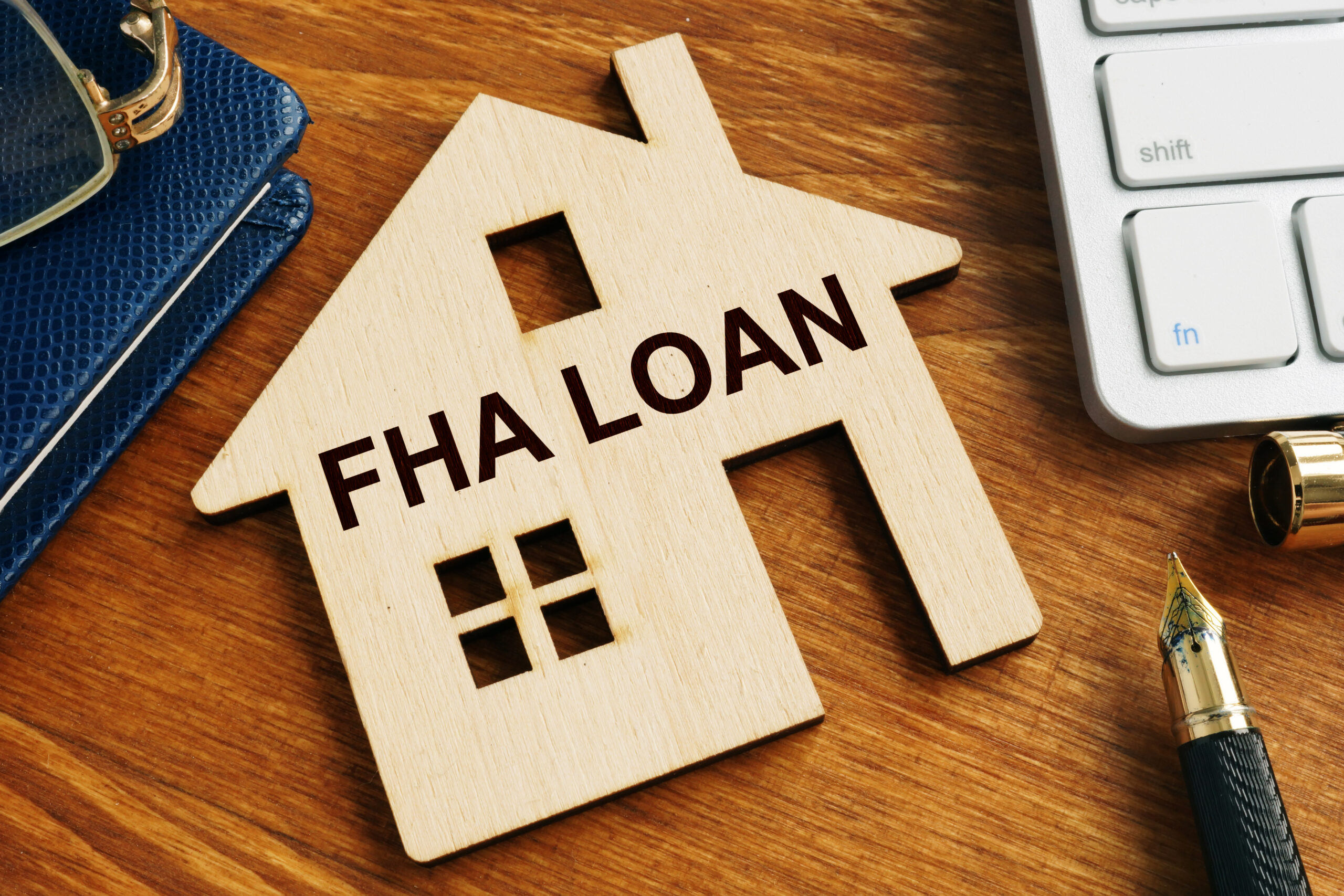 Wooden house shape with FHA loan text