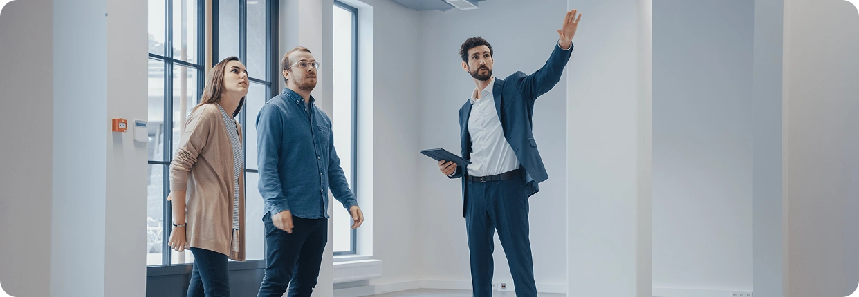 Couple touring a new apartment with agent